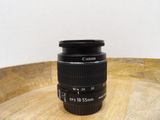 a camera lens sitting on top of a wooden table