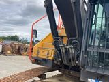 the back end of a yellow and black bulldozer parked in a parking lot