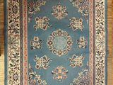 an image of a blue area rug on a wooden floor