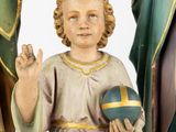 a statue of a child holding a ball in his hand
