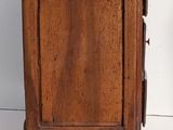 a small wooden cabinet with a drawer underneath it