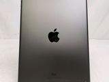 an apple ipad is sitting on a stand on a white surface
