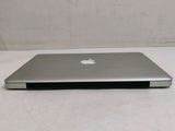 a silver apple laptop sitting on a white table