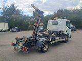 a white truck with a crane on the back of it