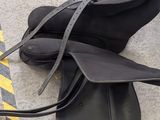 a pair of black shoes and a black purse on the ground