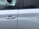 a dog sitting in the passenger seat of a car