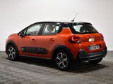 the orange car is parked on the checkered floor in the room