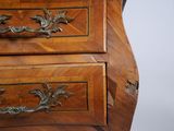 a wooden chest of drawers with ornate carvings on it