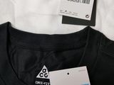 the nike tee shirt is white and has a blue and white tag on it
