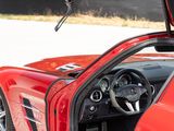 a red sports car with its doors open on the street