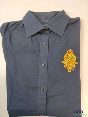 a close up of a blue shirt with a badge on it