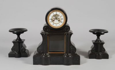 a small clock sitting on top of a table next to two stools