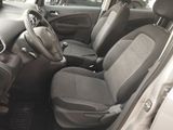 the interior of a small car with grey seats and a steering wheel
