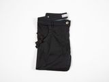 a pair of black pants sitting on top of a white surface