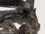 a close up of a pair of scissors on a piece of metal