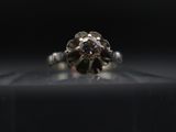 a close up of a diamond ring on a black surface