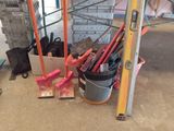 a bucket of paint and tools on the floor of a building