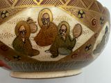 a picture of a decorative bowl with three people on it