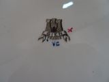 a white plate with a castle on it and a red star on it