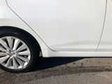 a small white car parked in a parking lot