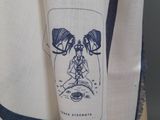 a close up of a white shirt with a drawing on it