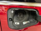 a close up of a car ' s fuel tank with a plugged in