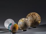 three different sized marbles sitting next to each other on top of a table