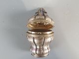 a small silver box with a lid on a table