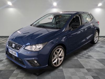 the blue ford focus is parked on a checkered floor