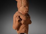 a clay statue of a man with a hat on his head