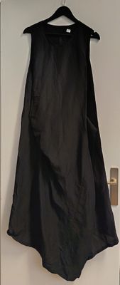 a black dress hanging up on a white door