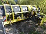 a yellow and black machine that is parked on the side of the road