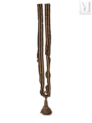 a close up of a brown and black striped scarf with a tassel