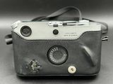a camera that is sitting on a table with a strap around it