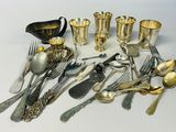 a lot of silver spoons and silverware on the table