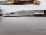 a knife and a pocket knife sitting on a table