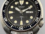 a close up of a wrist watch on a metal stand
