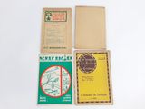 three small booklets are sitting on top of a white table