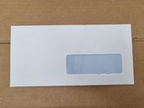 a close up of a white envelope sitting on top of a cardboard box