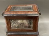 an image of a wooden box with a glass top sitting on a table