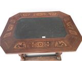 a wooden table with a black marble top on a stand