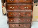 an antique chest of drawers with a marble top and brass handles