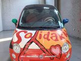 a small car that has been painted with hearts on it