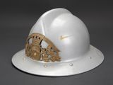 a white hard hat with a gold emblem on it