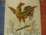 a painting of a rooster on the wall of a house