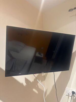 a flat screen tv hanging on a wall in a room