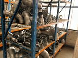many different types of pipes on the shelves in the warehouse