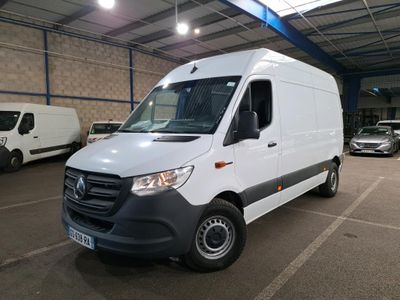the white van is parked in a large warehouse with other vehicles