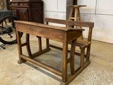 a wooden desk and a chair in a room