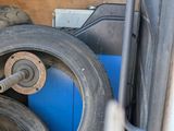 a pile of tires and other items in the back of a truck